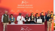 Doha Bu Thaila's connections celebrate after the Wathnan Racing-owned filly won the Al Waab Cup yesterday. Qatar Racing and Equestrian Club Racing Manager Abdulla Rashid Al Kubaisi honoured the winners. PICTURES: JUHAIM/QREC