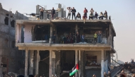 Gazans gather to watch as Hamas prepares to hand over Israeli hostage to a Red Cross team in Jabalia on January 30, 2025. (Photo by Omar Al-Qattaa / AFP)