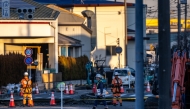 Rescue operations continue for a truck driver after his vehicle plunged into a sinkhole at in Yashio, Saitama Prefecture on January 30, 2025. (Photo by Philip Fong / AFP)