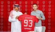 Hakim Ziyech poses with his Al Duhail jersey along with club’s official.   