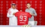 Hakim Ziyech poses with his Al Duhail jersey along with club’s official.   