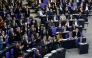 Leader of Germany's Christian Democratic Union (CDU) Friedrich Merz (front row L) looks on as his parliamentary group and of the Bavarian conservative Christian Social Union (CSU) party applaud while members of the far-right Alternative for Germany (AfD) look on during a debate at the Bundestag (lower house of parliament) focusing on immigration, on January 31, 2025 in Berlin. Photo by Odd ANDERSEN / AFP.