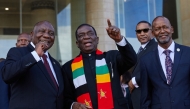 (From left) South African President Cyril Ramaphosa, President of Zimbabwe and SADC Chairman Emmerson Mnangagwa and SADC Executive Secretary Elias Magosi gesture ahead of the Southern African Development Community (SADC) extraordinary summit in Harare on January 31, 2025.  (Photo by Jekesai Njikizana / AFP)