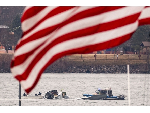 Recovery teams search the wreckage after the crash of an American Airlines plane on the Potomac River as it approached the airport on January 30, 2025 in Arlington, Virginia. (Photo by Al Drago/Getty Images/AFP)
