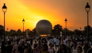 File: Visitors gather in front of the Olympic cauldron, an air balloon, lit with the Olympic flame in Paris on July 30, 2024. (Photo by Andrej Isakovic / AFP)