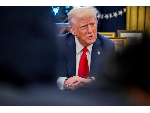 US President Donald Trump speaks to the press after signing an executive order in the Oval Office of the White House on January 30, 2025 in Washington, DC. (Photo by Roberto Schmidt / AFP)