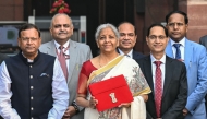 India's Finance Minister Nirmala Sitharaman (C) along with minister of state for finance Pankaj Chaudhary (C, left) poses as she leaves the ministry of finance to present the annual budget at the parliament in New Delhi on February 1, 2025. (Photo by Money Sharma / AFP)