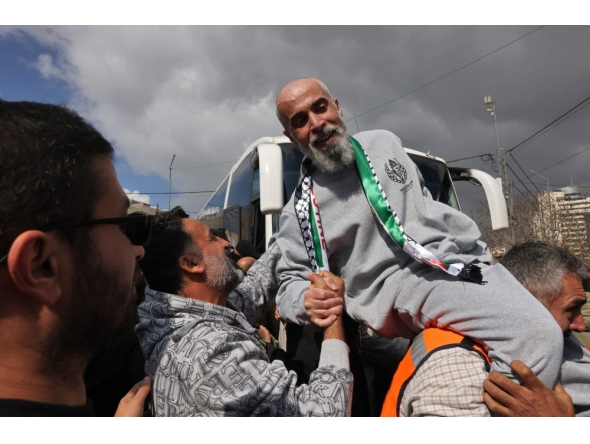 A former Palestinian prisoner is cheered upon his arrival in Ramallah on buses of the International Committee of the Red Cross (ICRC) on February 1, 2025. (Photo by Ahmad Gharabli / AFP)
