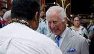 Britain's King Charles III speaks to dignitaries as he arrives at Apia Airport for the Commonwealth Heads of Government Meeting (CHOGM) in Apia, capital of Samoa, on October 23, 2024. (Photo by POOL / AFP)