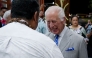 Britain's King Charles III speaks to dignitaries as he arrives at Apia Airport for the Commonwealth Heads of Government Meeting (CHOGM) in Apia, capital of Samoa, on October 23, 2024. (Photo by POOL / AFP)