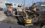 Excavators and rescue personnel working to construct a slope for rescue operations are seen at the site where a truck on January 28 plunged into a sinkhole, trapping the vehicle's driver, in Yashio, Saitama Prefecture on February 1, 2025. Photo by JIJI PRESS / AFP