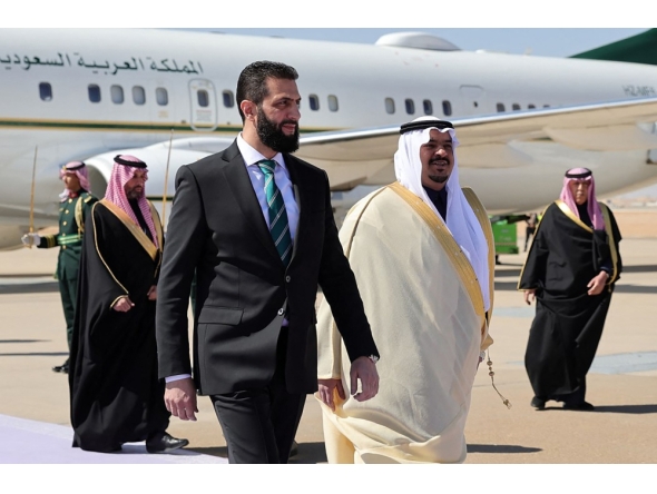 A handout picture released by the official Syrian Arab News Agency (SANA) on February 2, 2025, shows Syria's interim president Ahmed al-Sharaa (L), received by Prince Mohammed bin Abdulrahman bin Abdulaziz, Deputy Governor of Riyadh region, upon their arrival in Riyadh on his first foreign visit. (Photo by SANA / AFP) /