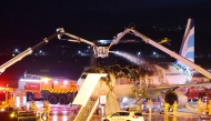 Firefighters work to extinguish a fire that broke out on an Air Busan passenger plane bound for Hong Kong, at Gimhae International Airport in Busan on January 28, 2025. Photo by YONHAP / AFP