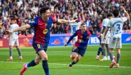 Barcelona's Polish forward #09 Robert Lewandowski (L) celebrates after scoring their first goal during the Spanish league football match between FC Barcelona and Deportivo Alaves at the Estadi Olimpic Lluis Companys in Barcelona on February 2, 2025. (Photo by Josep LAGO / AFP)