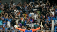 India's Abhishek Sharma celebrates after scoring a century (100 runs) during the fifth and final Twenty20 international cricket match between India and England at the Wankhede Stadium in Mumbai on February 2, 2025. (Photo by Punit PARANJPE / AFP)