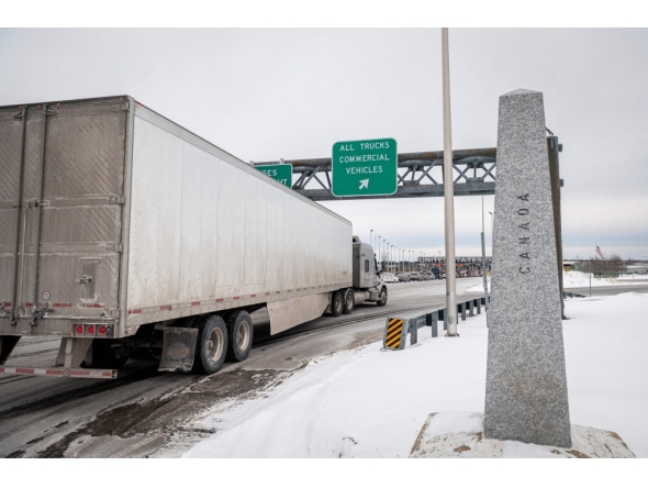 A truck drives on its way to enter the United States at a border crossing at the Canada-US border in Blackpool, Quebec, Canada, on February 2, 2025. (Photo by Andrej Ivanov / AFP)