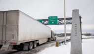 A truck drives on its way to enter the United States at a border crossing at the Canada-US border in Blackpool, Quebec, Canada, on February 2, 2025. (Photo by Andrej Ivanov / AFP)