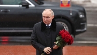 In this pool photograph distributed by the Russian state agency Sputnik, Russian President Vladimir Putin lays flowers at the monument 'Rubezhny Kamen' (Boundary Stone) in Kirovsk, Leningrad region, on January 27, 2025. (Photo by Vyacheslav Prokofyev / POOL / AFP)