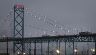 Trucks carry goods across the Ambassador Bridge from Canada into the United States on February 03, 2025 in Detroit, Michigan. Scott Olson/Getty Images/AFP