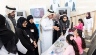 Dr. Hilal interacts with a staff manning one of the stands