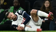 Tottenham Hotspur's Romanian defender #06 Radu Dragusin holds his knee in pain during the UEFA Europa League match between Tottenham Hotspur and IF Elfsborg at the Tottenham Hotspur Stadium in London, on January 30, 2025. (Photo by Ben STANSALL / AFP)
