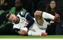 Tottenham Hotspur's Romanian defender #06 Radu Dragusin holds his knee in pain during the UEFA Europa League match between Tottenham Hotspur and IF Elfsborg at the Tottenham Hotspur Stadium in London, on January 30, 2025. (Photo by Ben STANSALL / AFP)
