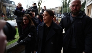 Chelsea's Australian striker Sam Kerr (C) reacts as she arrives at Kingston Crown Court in south London on February 3, 2025, for the start of her trial. (Photo by HENRY NICHOLLS / AFP)
