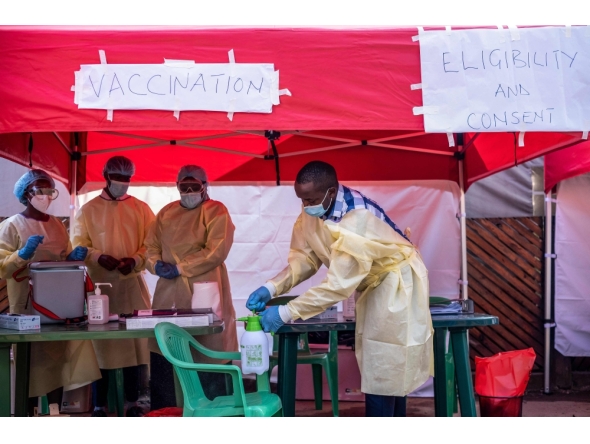 Medical personnel wear protective medical clothing while disinfecting the area in preparation for the arrival of volunteers during the launch of an Ebola trial vaccination campaign at Mulago Referral Hospital in Kampala on February 3, 2025. (Photo by Badru Katumba / AFP)
