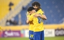 Al Gharafa's Ferjani Sassi celebrates with Ahmed Al Ganehi after scoring a goal.