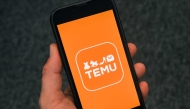 This photo illustration shows the logo of fast fashion e-commerce company Temu displayed on a mobile phone in Brussels, on November 4, 2024. Photo by Nicolas TUCAT / AFP