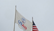 (FILES) A USAID and American flag fly before Congressional Democrats hold news conference outside of United States Agency for International Development (USAID) headquarters in Washington, DC, on February 3, 2025. (Photo by Mandel NGAN / AFP)
