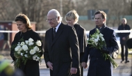 From left: Sweden's Queen Silvia and King Carl XVI Gustaf of Sweden, Prime Minister Ulf Kristersson with his wife Birgitta Ed arrive at the memorial to place flowers outside the adult education center Campus Risbergska school in Orebro, Sweden, on February 5, 2025. (Photo by Jonathan Nackstrand / AFP)