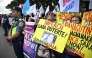 Protesters carry placards during a rally in front of the House of Representatives in Manila on February 5, 2025, as lawmakers voted to impeach Philippine Vice-President Sara Duterte. (Photo by Ted Aljibe / AFP)