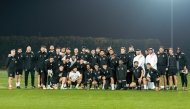 Al Sadd's Akram Afif poses with teammates and officials along with the AFC Player of the Year trophy.