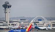 Photo used for representational purposes. A Southwest Airlines Boeing 737-700 airplane taxis past American Airlines and Alaska Airlines airplanes at Los Angeles International Airport (LAX) in Los Angeles, California on January 31, 2025. Photo by Patrick T. Fallon / AFP.
