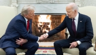 (Files) US President Joe Biden shakes hands with US President-elect Donald Trump during a meeting in the Oval Office of the White House in Washington, DC, on November 13, 2024. (Photo by SAUL LOEB / AFP)
 