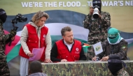 A member of the Red Cross team signs documents before Palestinian Hamas fighters handover three Israeli hostages in Deir el-Balah, central Gaza, on February 8, 2025. (Photo by Eyad BABA / AFP)