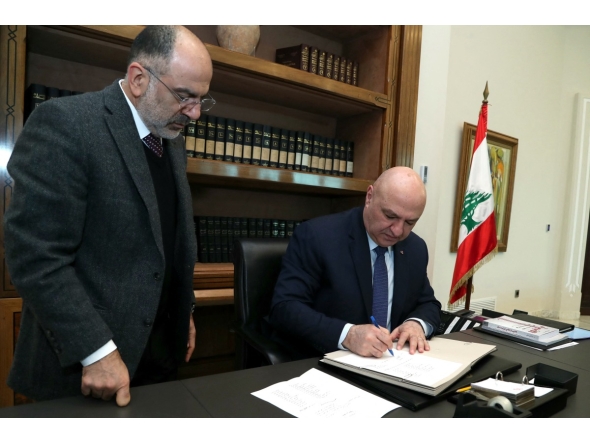 This handout picture released by the Lebanese presidency shows President Joseph Aoun (C) signing a decree at the presidential palace in Baabda, east of Beirut on February 8, 2025. (Photo by Lebanese Presidency / AFP)