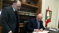 This handout picture released by the Lebanese presidency shows President Joseph Aoun (C) signing a decree at the presidential palace in Baabda, east of Beirut on February 8, 2025. (Photo by Lebanese Presidency / AFP)