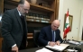 This handout picture released by the Lebanese presidency shows President Joseph Aoun (C) signing a decree at the presidential palace in Baabda, east of Beirut on February 8, 2025. (Photo by Lebanese Presidency / AFP)