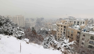 A layer of snow blankets Tehran as seen from the Tochal mountain resort, on February 9, 2025. (Photo by ATTA KENARE / AFP)
