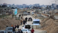 Displaced Palestinians cross the Netzarim corridor as they make their way to the northern parts of the Gaza Strip on February 9, 2025. (Photo by Eyad BABA / AFP)
