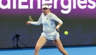 Ekaterina Alexandrova returns a shot to Emma Raducanu.