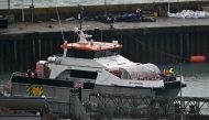 UK Border Force vessel 'Typhoon', carrying migrants picked up at sea attempting to cross the English Channel from France, arrives at the Marina in Dover, southeast England, on February 9, 2025. (Photo by Ben STANSALL / AFP)