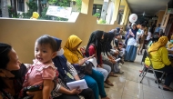 People wait at a community health centre during the opening day of the nationwide free health check-up (PKG) programme in Surabaya on February 10, 2025. (Photo by JUNI KRISWANTO / AFP)