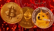 File photo: Representations of Cryptocurrencies Bitcoin, Ethereum and DogeCoin are placed on PC motherboard in this illustration taken, June 29, 2021. (REUTERS/Dado Ruvic)