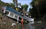 Firefighters work at the scene of an accident in which a bus fell down a ravine in Guatemala City on February 10, 2025. Photo by Johan ORDONEZ / AFP