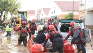 File: This handout photo taken by the UME-Spanish Military Emergencies Unit shows Spanish rescuers taking residents on a dinghy boat following deadly flooding, in Valencia, on October 30, 2024. (Photo by Handout / UME / AFP)