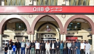 QIIB’s CEO Dr Abdulbasit Ahmad Al Shaibei with senior executives and employees pose for a group photo.