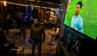 Men watch UEFA Champions League match Manchester City against Real Madrid, at a cafe in Cairo on February 11, 2025. (Photo by Khaled Desouki / AFP)